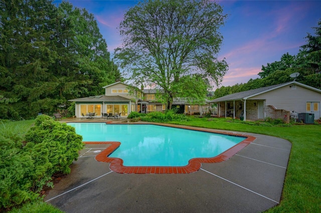 938 Meadow Cir, Bethlehem, PA 18017 - pool at dusk featuring an outdoor pool, a lawn, and a patio area