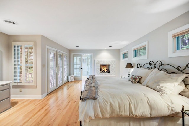 938 Meadow Cir, Bethlehem, PA 18017 - bedroom featuring light wood-style flooring, a premium fireplace, and access to exterior