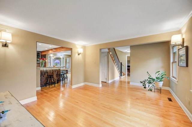 938 Meadow Cir, Bethlehem, PA 18017 - living area with wood finished floors, stairway, a dry bar, and crown molding