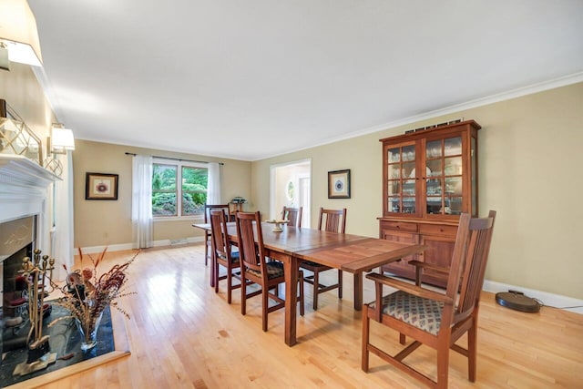 938 Meadow Cir, Bethlehem, PA 18017 - dining space with light wood finished floors, a high end fireplace, and ornamental molding