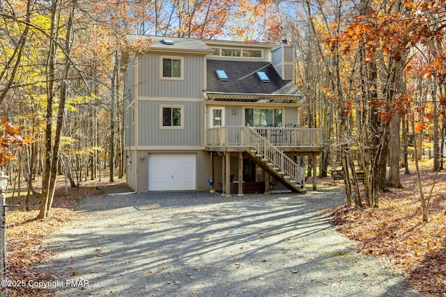 view of front of property with a chimney, a shingled roof, a garage, driveway, and stairs