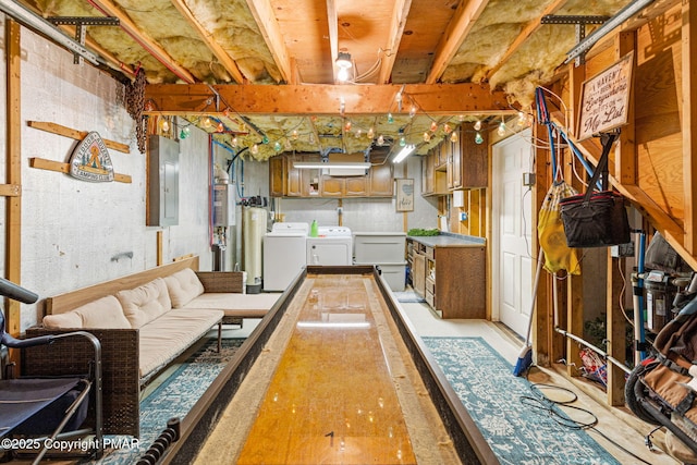 unfinished basement featuring electric panel and washer and dryer