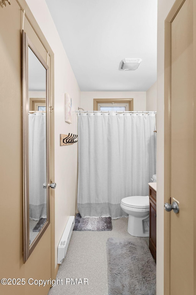 bathroom featuring visible vents, toilet, a shower with curtain, vanity, and a baseboard heating unit