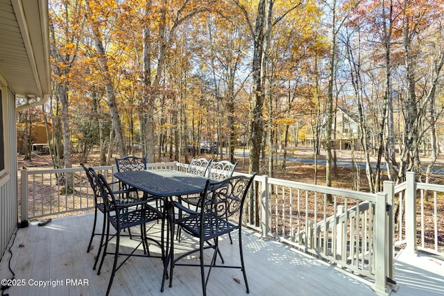 wooden terrace with outdoor dining area