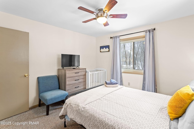 carpeted bedroom featuring ceiling fan and baseboards