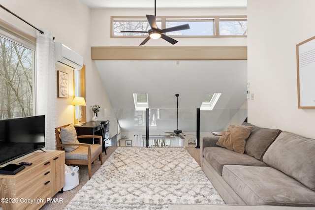 living room featuring ceiling fan, an AC wall unit, and a skylight