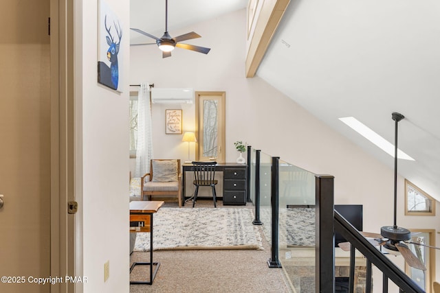 hall with carpet floors, lofted ceiling with skylight, and an AC wall unit