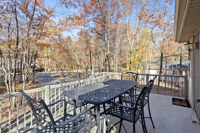 wooden terrace featuring outdoor dining area