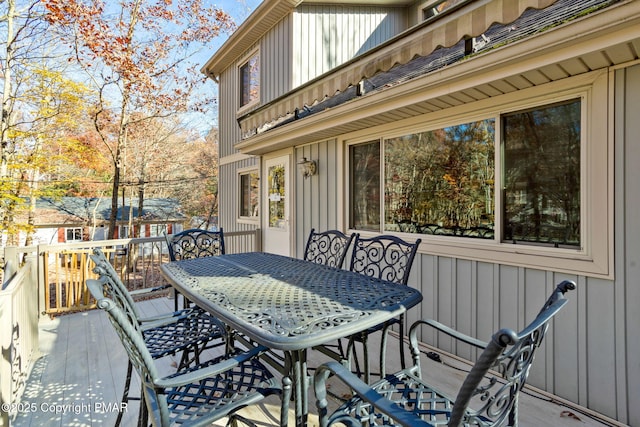 wooden deck featuring outdoor dining area