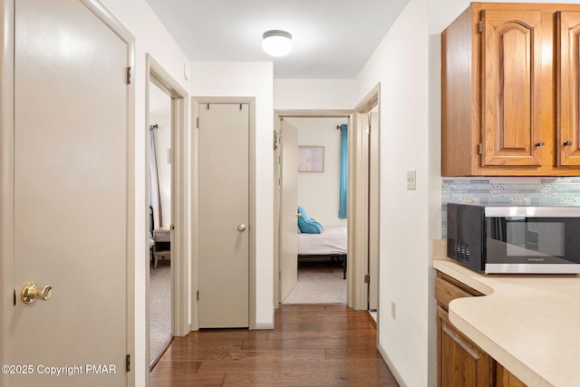 hallway featuring dark wood-type flooring