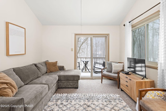 living room featuring carpet floors and vaulted ceiling