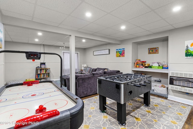 playroom with heating unit, a paneled ceiling, and recessed lighting