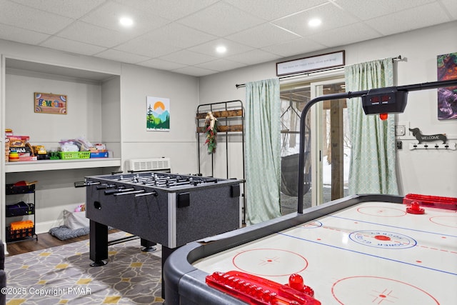 playroom featuring baseboards, a drop ceiling, washer / dryer, and recessed lighting