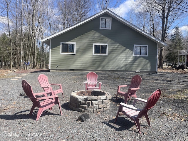 back of property featuring an outdoor fire pit
