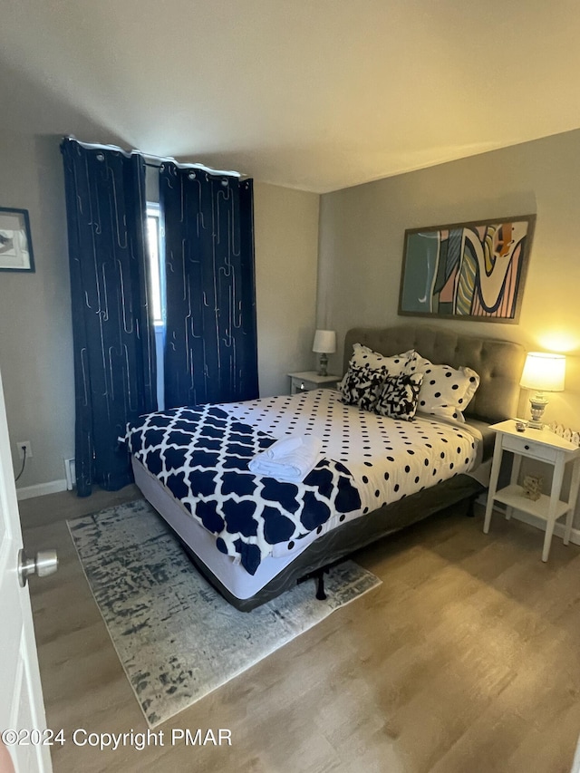 bedroom featuring wood finished floors