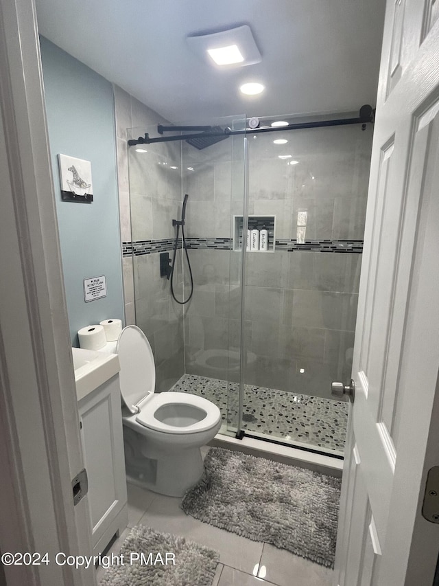 full bathroom with vanity, tile patterned floors, a shower stall, and toilet