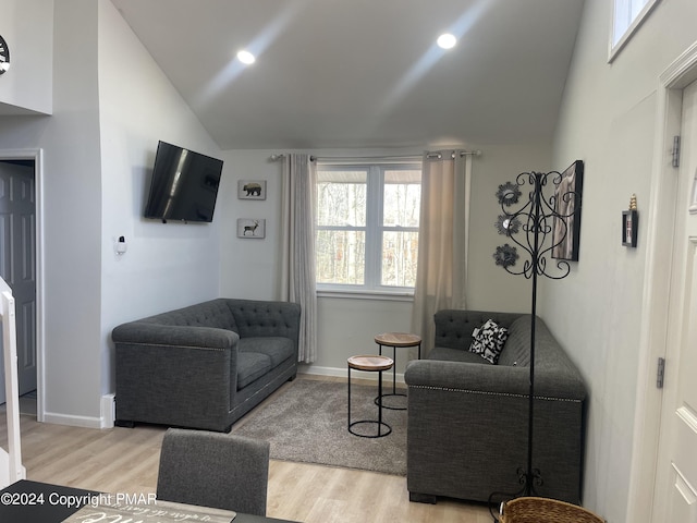 living area featuring recessed lighting, baseboards, light wood-type flooring, and lofted ceiling