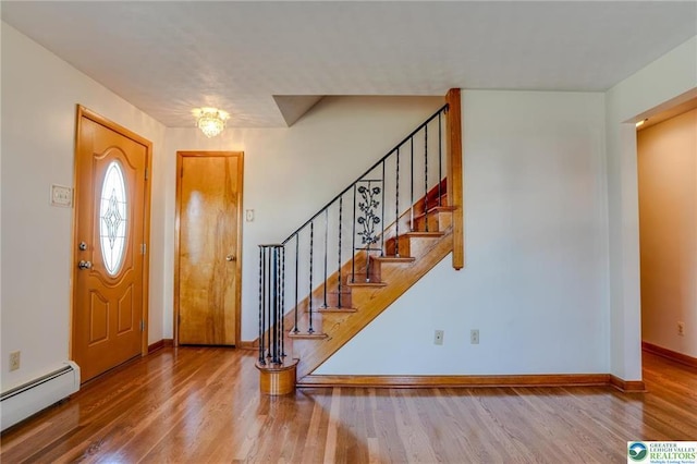 829 E Main St, Weatherly, PA 18255 - entrance foyer with a baseboard heating unit, wood finished floors, stairs, and baseboards