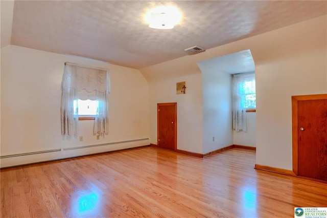 829 E Main St, Weatherly, PA 18255 - spare room with baseboard heating, light wood-type flooring, baseboards, and vaulted ceiling