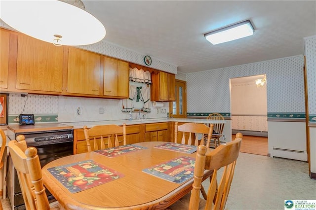 829 E Main St, Weatherly, PA 18255 - kitchen featuring wallpapered walls, a baseboard radiator, light countertops, and a wainscoted wall