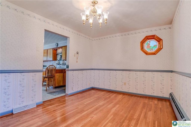829 E Main St, Weatherly, PA 18255 - unfurnished room with wallpapered walls, baseboard heating, light wood-style flooring, and a chandelier