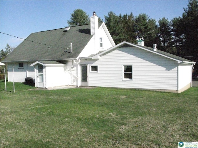 829 E Main St, Weatherly, PA 18255 - rear view of house with a chimney and a lawn