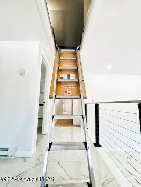 stairs featuring marble finish floor and baseboards