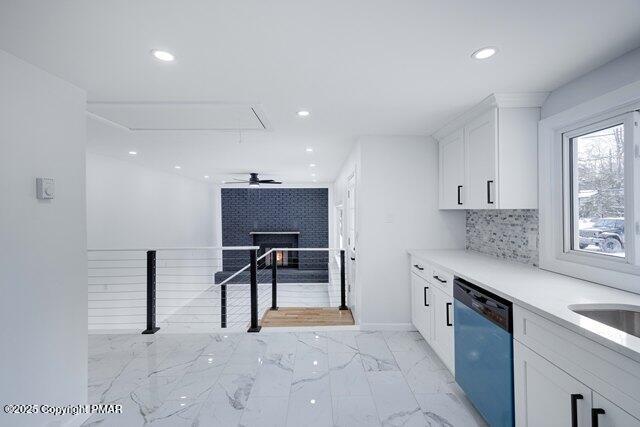 kitchen with dishwashing machine, recessed lighting, decorative backsplash, white cabinetry, and marble finish floor