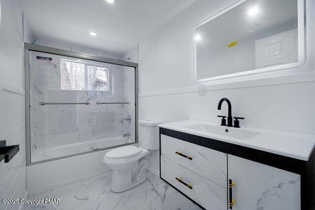 bathroom with toilet, marble finish floor, combined bath / shower with glass door, recessed lighting, and vanity