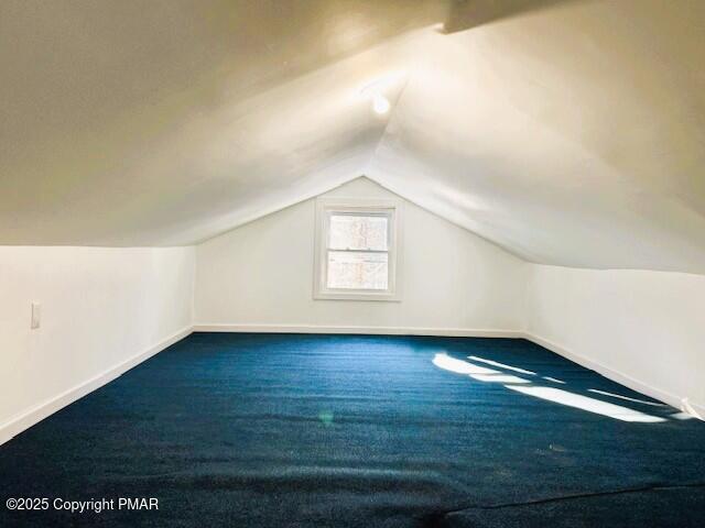 bonus room with baseboards, carpet floors, and vaulted ceiling