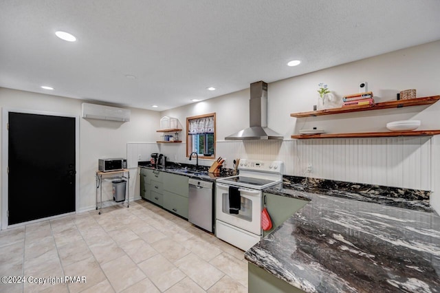 kitchen with open shelves, wall chimney range hood, a wall unit AC, appliances with stainless steel finishes, and a sink