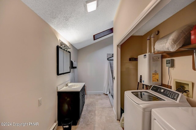 laundry room featuring baseboards, water heater, laundry area, independent washer and dryer, and a textured ceiling