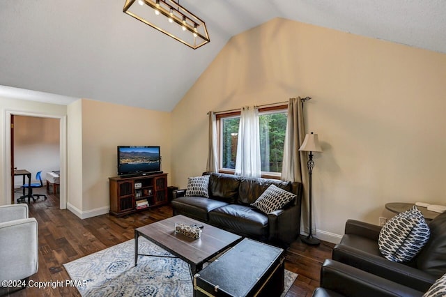 living room featuring baseboards, lofted ceiling, and wood finished floors