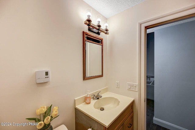 bathroom featuring vanity and a textured ceiling