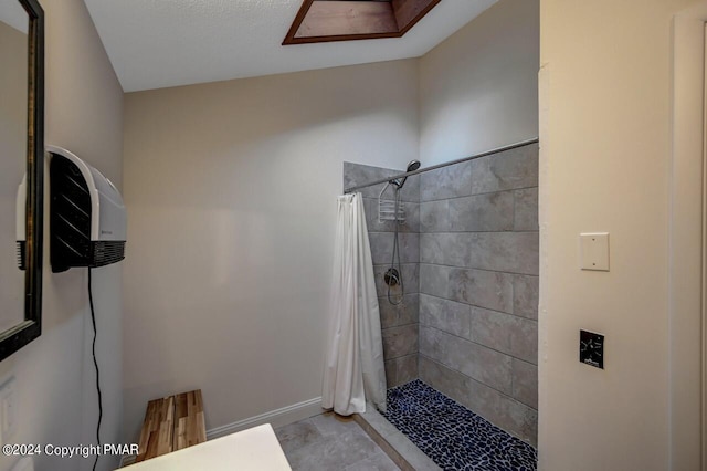 full bathroom featuring baseboards and a stall shower