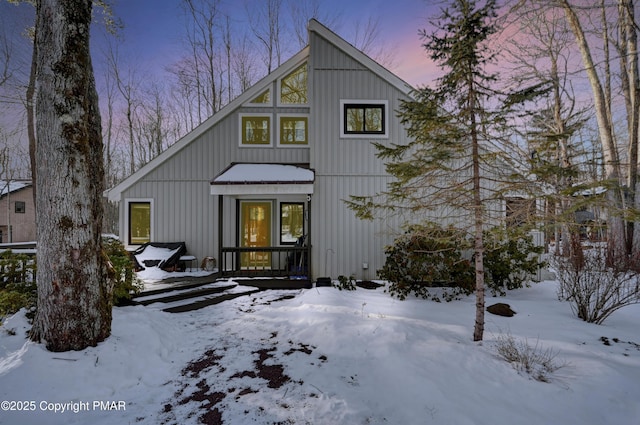 view of snow covered rear of property