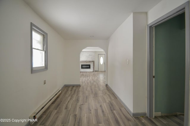 hallway with hardwood / wood-style flooring and a baseboard radiator