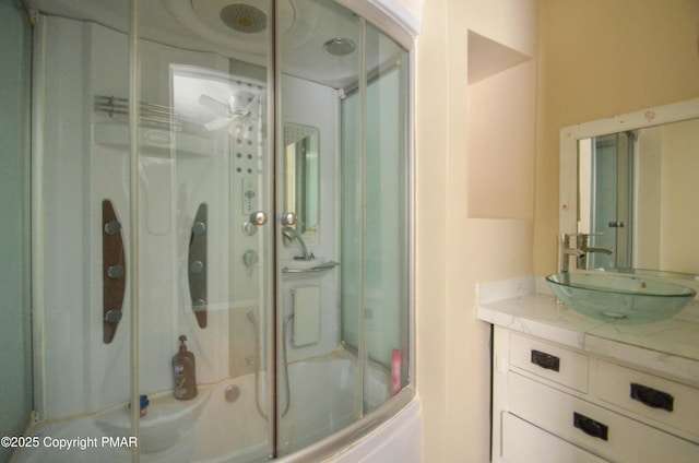 bathroom featuring vanity and bath / shower combo with glass door