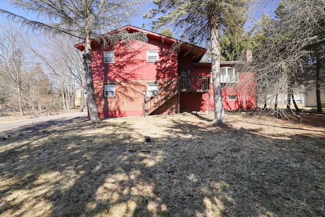 view of property exterior featuring stairway and brick siding