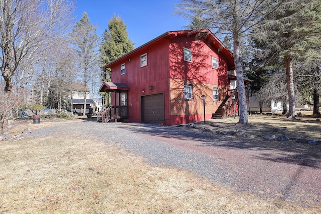 view of property exterior featuring a garage and driveway