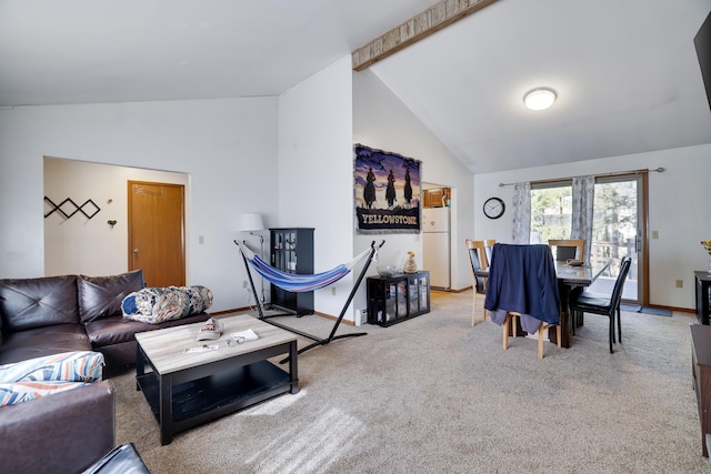 carpeted living area featuring baseboards and high vaulted ceiling