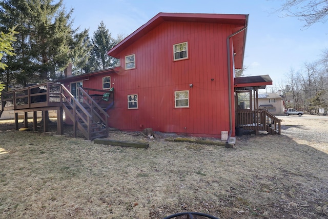 rear view of property featuring stairway