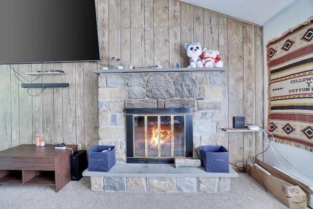 interior details featuring carpet flooring and a stone fireplace