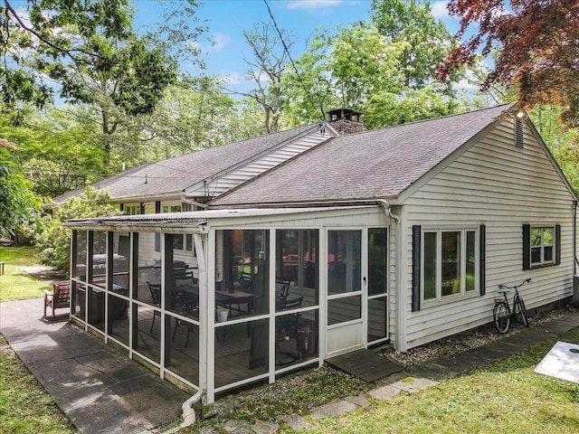 742 White Oak Rd, Cresco, PA 18326 - rear view of property featuring a shingled roof, a sunroom, and a chimney