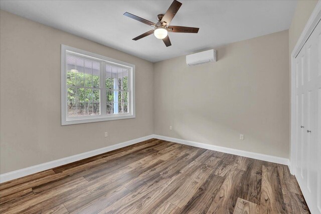 111 Parker Mews, Albrightsville, PA 18210 - unfurnished bedroom featuring a wall mounted air conditioner, a closet, baseboards, wood finished floors, and a ceiling fan