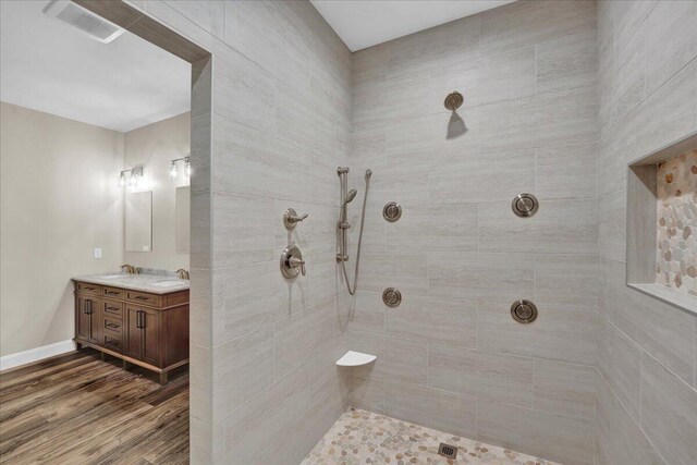 111 Parker Mews, Albrightsville, PA 18210 - full bathroom with wood finished floors, vanity, a tile shower, and baseboards
