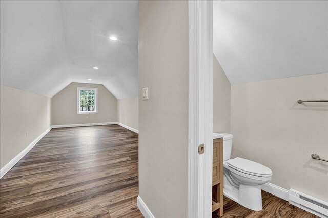 111 Parker Mews, Albrightsville, PA 18210 - bathroom featuring baseboard heating, vaulted ceiling, toilet, wood finished floors, and baseboards