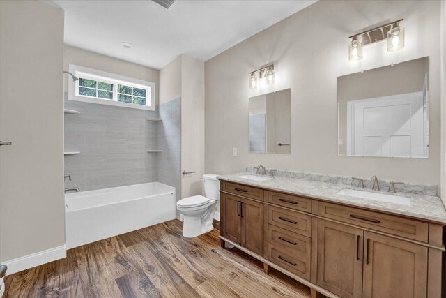 111 Parker Mews, Albrightsville, PA 18210 - bathroom featuring double vanity, toilet, wood finished floors, and tub / shower combination