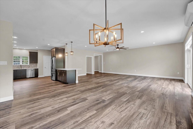 111 Parker Mews, Albrightsville, PA 18210 - unfurnished living room with ceiling fan, wood finished floors, a chandelier, a sink, and recessed lighting