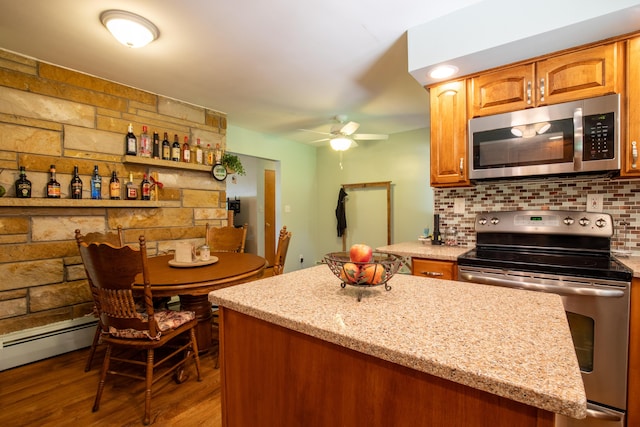 7035 Scenic Dr, Bloomsburg, PA 17815 - kitchen featuring stainless steel appliances, ceiling fan, light stone countertops, dark wood finished floors, and tasteful backsplash